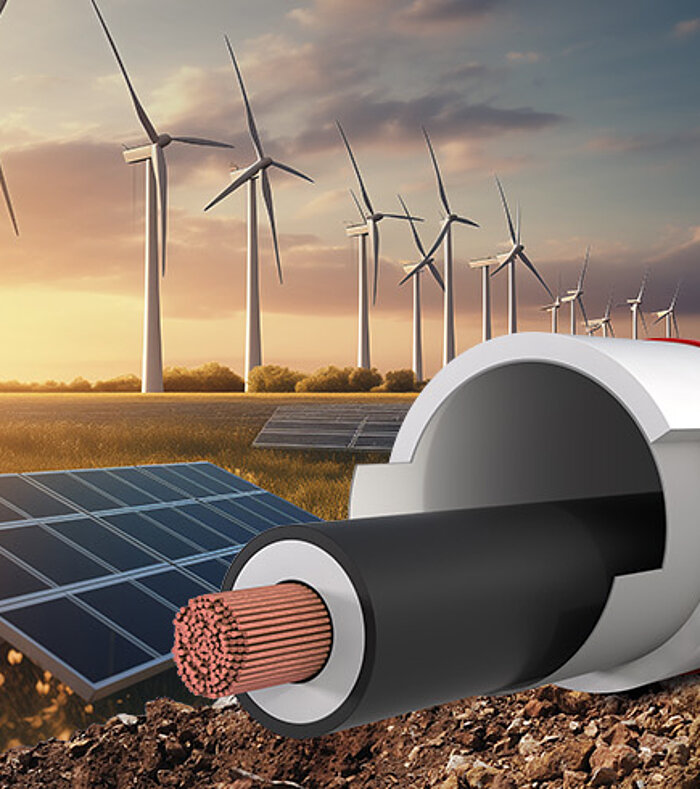 Symbolic image for infrastructure: Cross-section of a cable protection pipe in the foreground, with solar panels and wind turbines at sunset.
